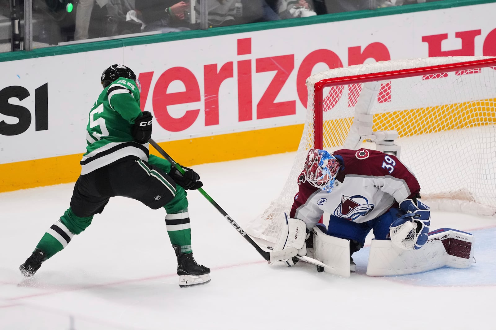 Colorado Avalanche goaltender Mackenzie Blackwood (39) blocks a shot by Dallas Stars' Thomas Harley (55) in the third period in Game 7 of a first-round NHL hockey playoff series Saturday, May 3, 2025, in Dallas. (AP Photo/Julio Cortez)