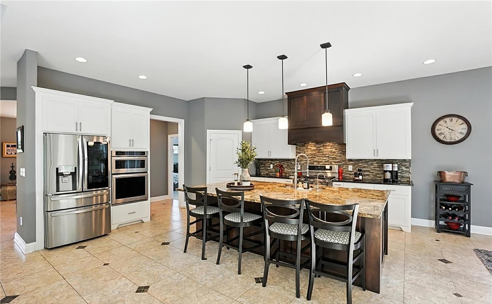The kitchen is open to the great room and has a breakfast bar, high end appliances, a breakfast area and a bar at the island.