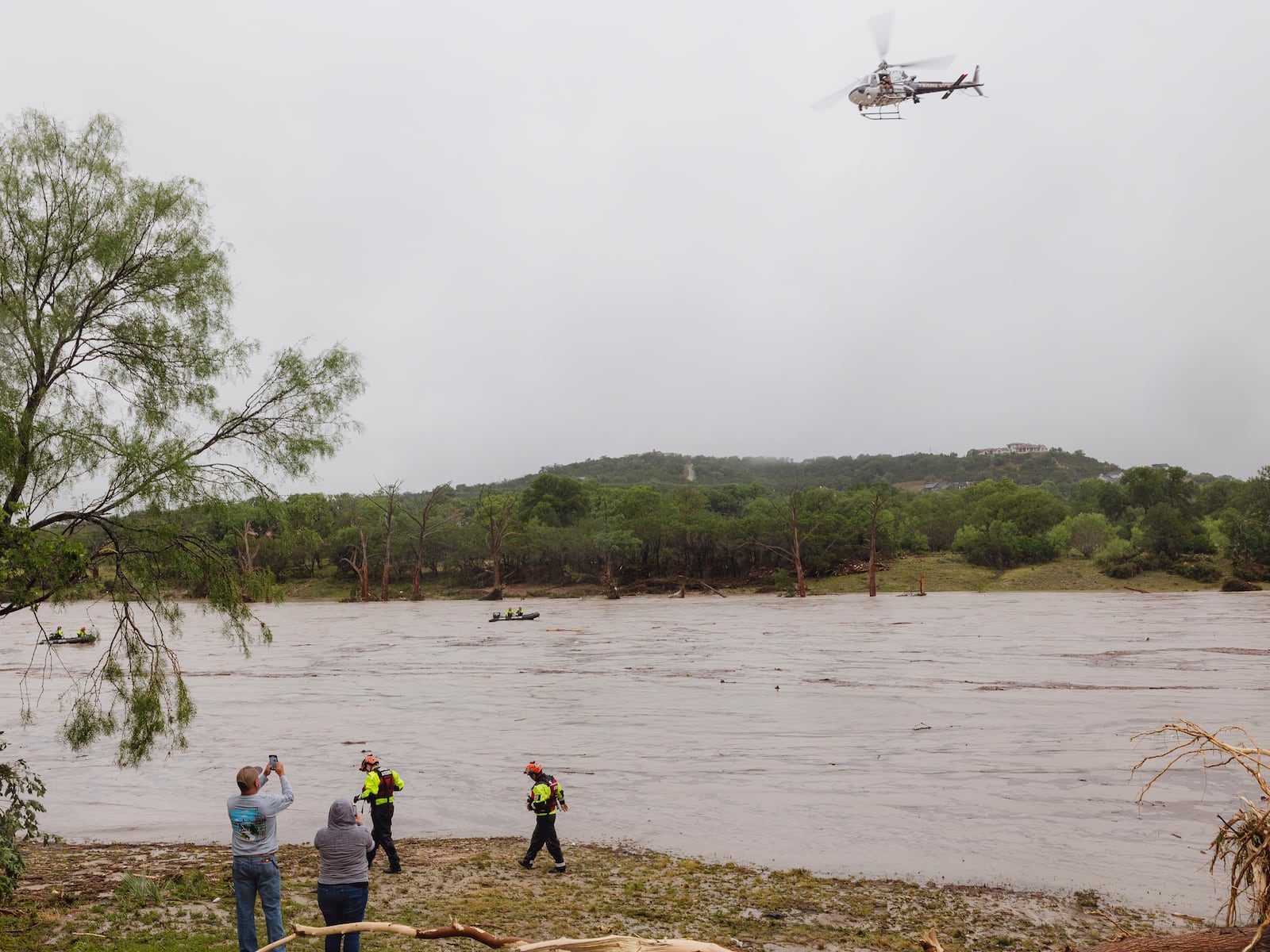 A Texas DPS helicopter conducts arial searches along the Guadalupe River in the wake of a destructive flooding event in Kerrville on Friday July 4, 2025. (Christopher Lee/The San Antonio Express-News via AP)