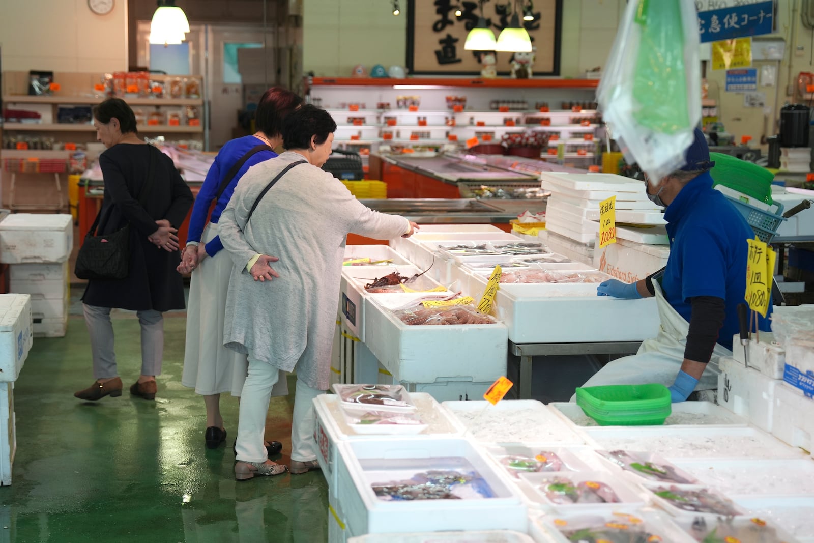 FILE - Visitors check seafood sold at the seafood market "Lalamew" near the Onahama fish port in Iwaki City, Fukushima Prefecture, on Oct. 19, 2023 in Iwaki, northeastern Japan. (AP Photo/Eugene Hoshiko, File)