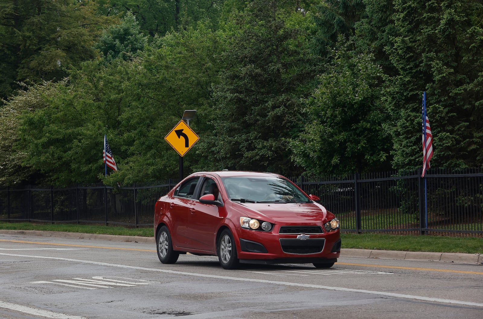 A car travels on McCreight Avenue on Tuesday, May 13, 2025, outside Ferncliff Cemetery. The fence has been hit by cars 65 times since 2018 and cemetery workers have advocated for changes to stop the accidents. JOSEPH COOKE/STAFF

