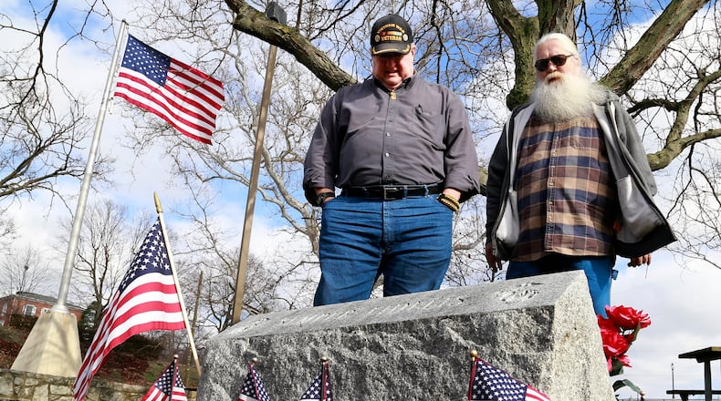 Randy Ark, left, and Roger Warren look over the Marine Corp memorial that Warren and his Maine Corp. brothers dedicated in 1988 at Veteran’s Park. Bill Lackey/Staff