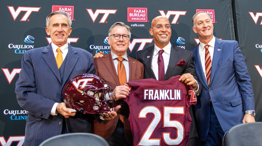 FILE - James Franklin, second from right, Virginia Tech's new head football coach, holds up a No. 25 jersey with, from left, Virginia Tech Board of Visitors memver John Rocovich, Virginia Tech President Timothy Sands and Athletic Director Whit Babcock, after Franklin was introduced during an NCAA college football news conference, Wednesday, Nov. 19, 2025, in Blacksburg, Va. (AP Photo/Robert Simmons, File)