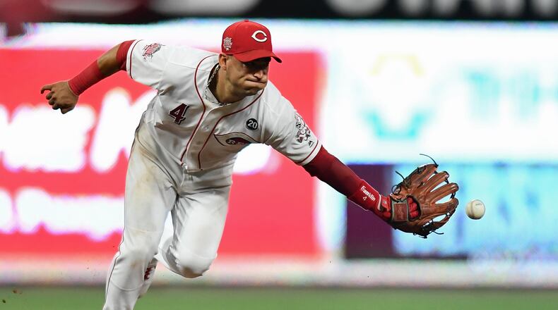 CINCINNATI, OH - JULY 19: Jose Iglesias #4 of the Cincinnati Reds tosses the ball to second base after fielding a ground ball in the sixth inning against the St. Louis Cardinals at Great American Ball Park on July 19, 2019 in Cincinnati, Ohio. All runners were safe on the play. (Photo by Jamie Sabau/Getty Images)