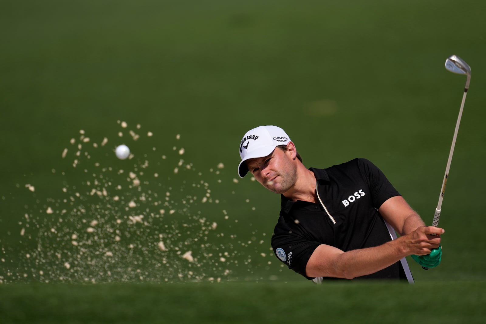 Thomas Detry, of Belgium, hits from the bunker on the second hole during the first round at the Masters golf tournament, Thursday, April 10, 2025, in Augusta, Ga. (AP Photo/George Walker IV)