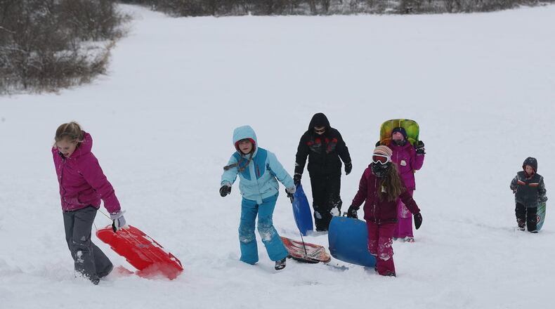 Sledders at Reid Park on day off from school this winter because of snow. BILL LACKEY/STAFF