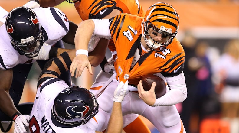 CINCINNATI, OH - NOVEMBER 16: J.J. Watt #99 of the Houston Texans sacks Andy Dalton #14 of the Cincinnati Bengals during the fourth quarter at Paul Brown Stadium on November 16, 2015 in Cincinnati, Ohio. Houston defeated Cincinnati 10-6. (Photo by Andy Lyons/Getty Images)