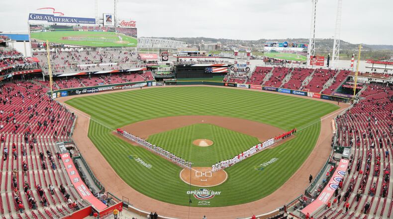 The Reds and Cardinals stand for the national anthem on Opening Day on Thursday, April 1, 2021, at Great American Ball Park in Cincinnati. David Jablonski/Staff