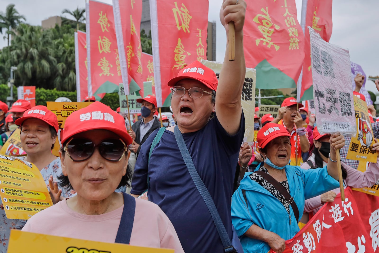 Taiwanese workers shout slogans during a May Day rally in Taipei, Taiwan, Thursday, May 1, 2025. (AP Photo/Chiang Ying-ying)
