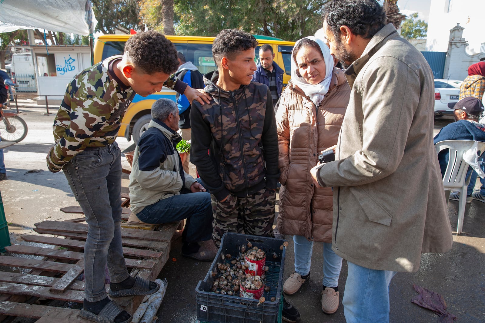 Customers buy snails at a weekly market in Enfidha, Tunisia, March 27, 2025. (AP Photo/Ons Abid)