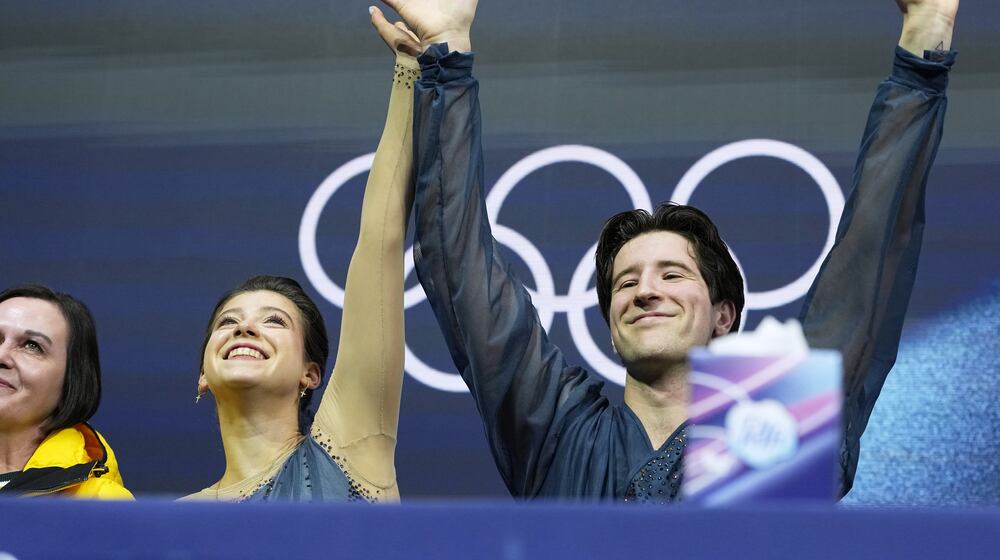 Anastasiia Golubeva and Hektor Giotopoulos Moore of Australia wait for scores after competing, during the pairs figure skating short program at the 2026 Winter Olympics, in Milan, Italy, Sunday, Feb. 15, 2026. (AP Photo/Natacha Pisarenko)