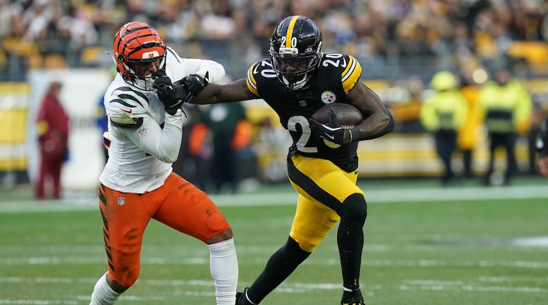 Pittsburgh Steelers running back Kaleb Johnson (20) facemasks Cincinnati Bengals safety Geno Stone (22) during the second half of an NFL football game Sunday, Nov. 16, 2025, in Pittsburgh. (AP Photo/Matt Freed)
