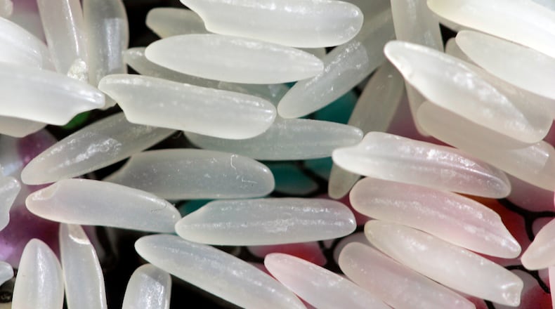 FILE - Grains of uncooked jasmine rice appear in Harrisburg, Pa., on April 24, 2008. (AP Photo/Carolyn Kaster, File)