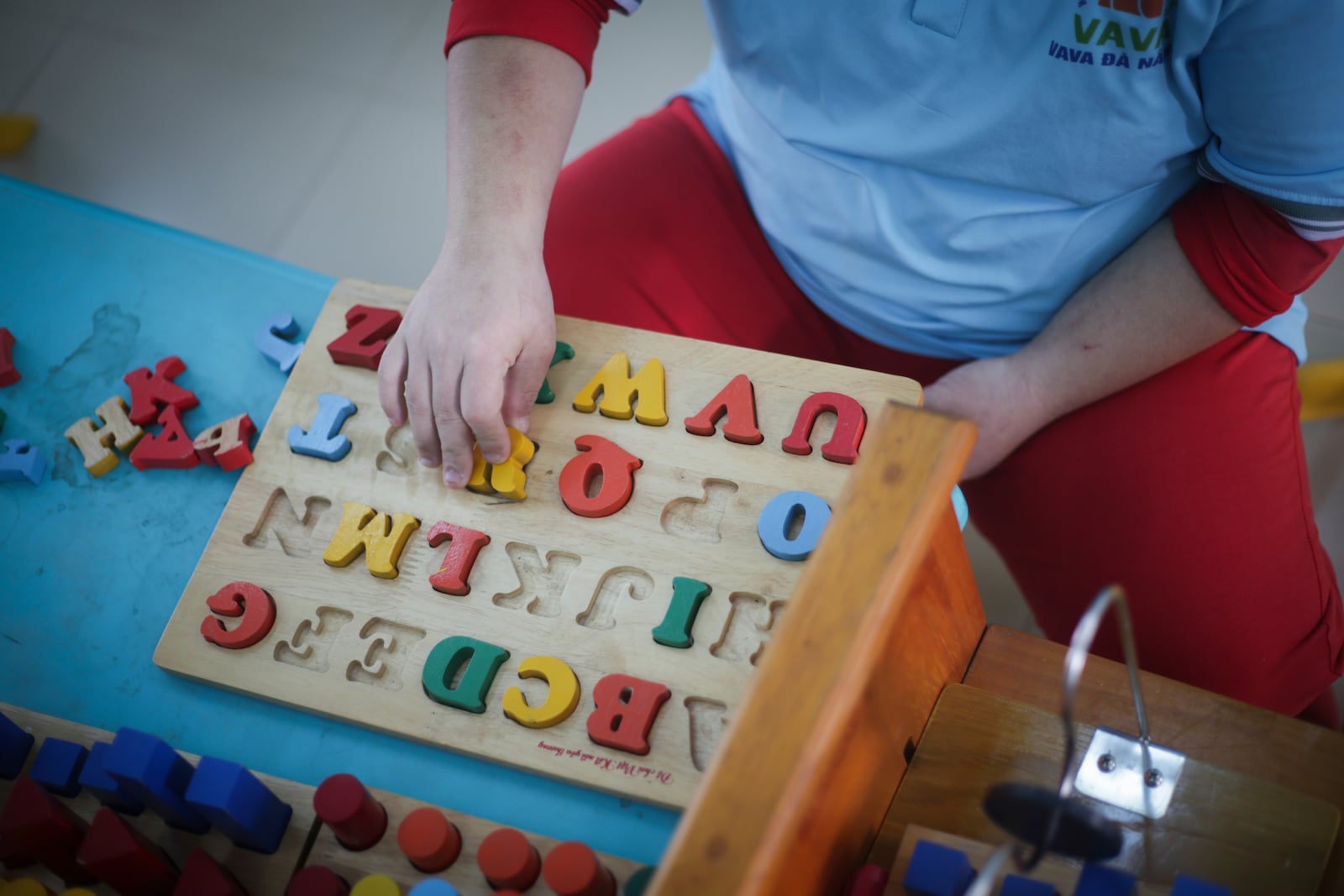 A student plays with a wooden shape sorter at a school for victims of Agent Orange in Da Nang, Vietnam, March 7, 2025. (AP Photo/Hau Dinh)