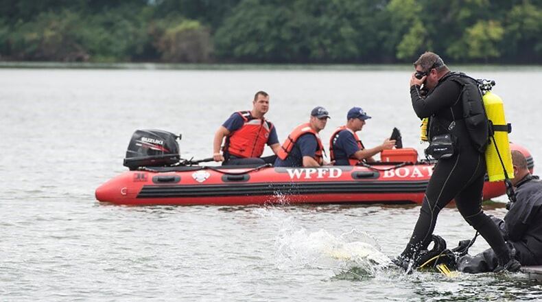 A diver from the 788th Civil Engineer Squadron Fire Department steps into the water to search for a reported drowning subject as part of a base exercise at Wright-Patterson Air Force Base July 31, 2018. Approximately a quarter of the base firefighters are dive qualified as the department is responsible for water rescue for several lakes on base and a portion of the Mad River. U.S. AIR FORCE PHOTO/WESLEY FARNSWORTH