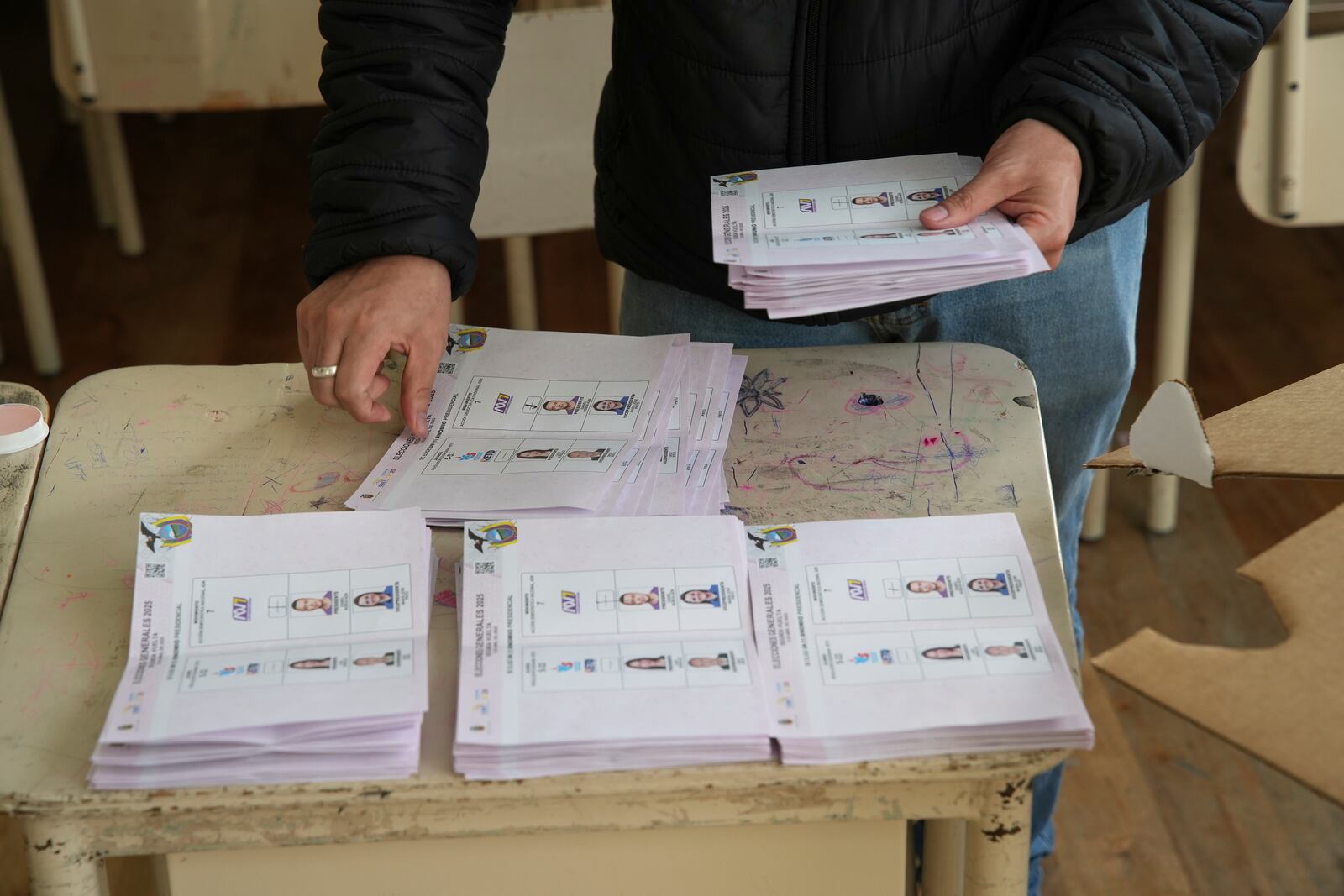 Electoral officials count ballots after polls close in the presidential election runoff in Quito, Ecuador, Sunday, April 13, 2025. (AP Photo/Carlos Noriega)