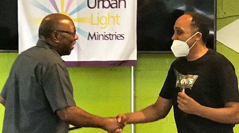 Urban Light Ministries CEO Eli Williams (left) congratulates James Wallace, one of 23 Community Fatherhood Award winners, at a ceremony in 2020. CONTRIBUTED