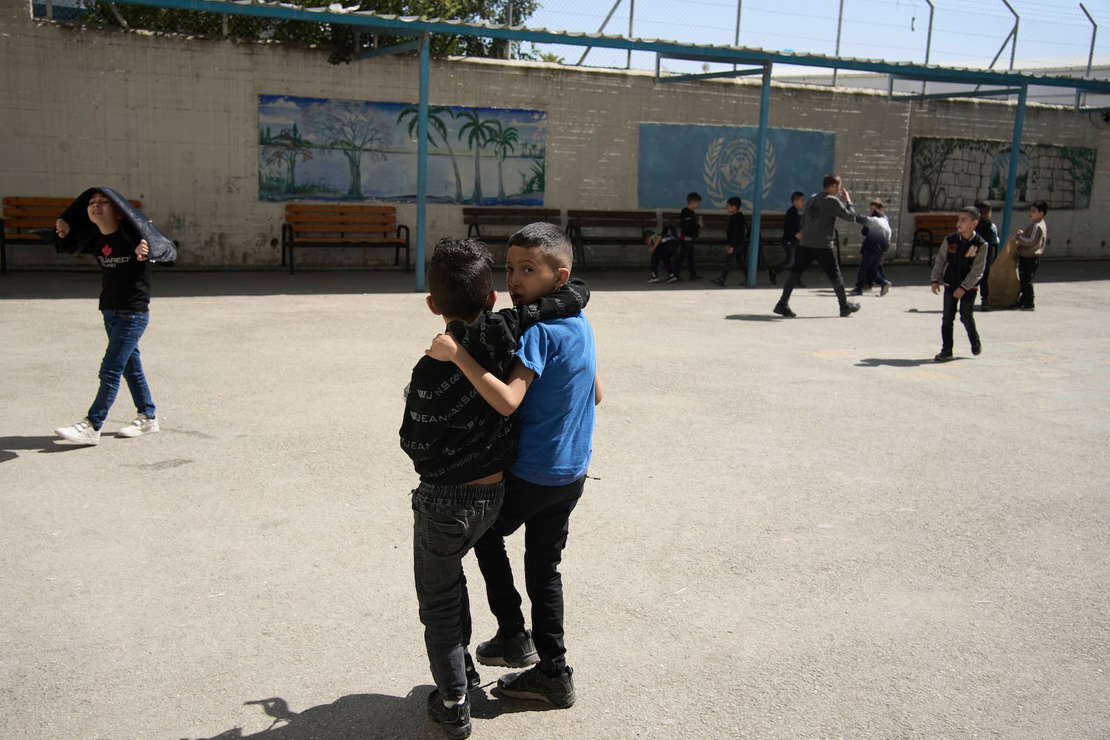 Students play outside during recess at the UNRWA Boys' School run by the U.N. agency for Palestinian refugees in the Shuafat Refugee Camp in east Jerusalem, Tuesday, April 29, 2025. (AP Photo/Maya Alleruzzo)