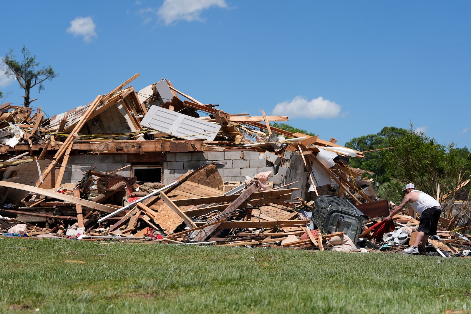 A person looks through the damage at a destroyed home, Saturday, May 17, 2025, in London, Ky (AP Photo/Carolyn Kaster)