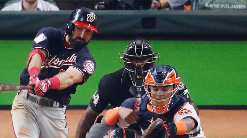 The Nationals' Adam Eaton hits an RBI single against the Houston Astros during the fifth inning in Game One of the 2019 World Series at Minute Maid Park on October 22, 2019 in Houston, Texas. (Photo by Tim Warner/Getty Images)