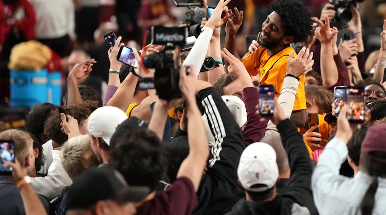 Arizona State guard Maurice Odum celebrates with fans after defeating Texas Tech during an NCAA college basketball game, Tuesday, Feb. 17, 2026, in Tempe, Ariz. (AP Photo/Rick Scuteri)