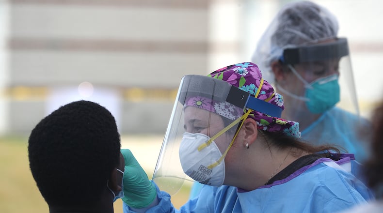 A young man gets a COVID-19 at the free testing clinic held in July by the Clark County Combined Health District. As of Monday, Clark County had the highest rate of COVID-19 cases in the state. BILL LACKEY/STAFF
