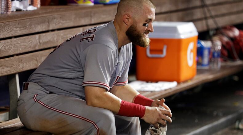 Cincinnati Reds catcher Tucker Barnhart sits in the dugout after the Reds lost to the Miami Marlins 7-4 in a baseball game, Friday, July 28, 2017, in Miami. (AP Photo/Lynne Sladky)
