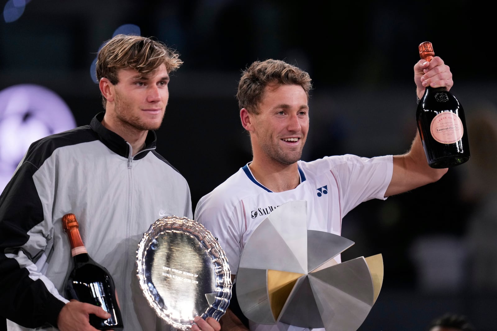 Britain's Jack Draper, left and the winner Norway's Casper Ruud stand on the podium after the Madrid Open tennis final in Madrid, Spain, Sunday, May 4, 2025. (AP Photo/Manu Fernandez)