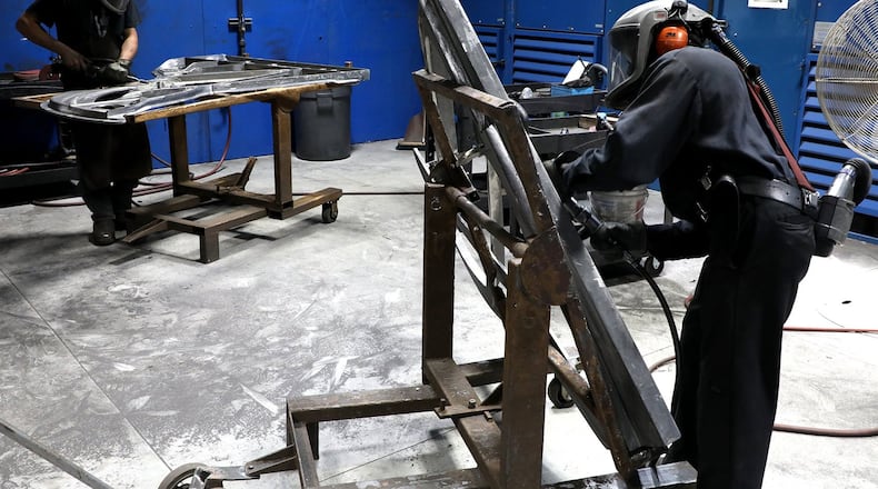 Workers at The O.S. Kelly Company grind and smooth-out the piano boards after they’ve been cast Monday, July 2, 2018 at the Springifeld company. The O.S. Kelly Company makes the piano boards for Steinway and Sons pianos. They have been in business since 1852. BILL LACKEY/STAFF