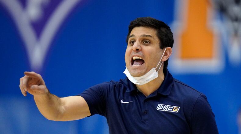UNC-Greensboro head coach Wes Miller directs his team against Mercer in the second half of an NCAA men's college basketball championship game in the Southern Conference tournament, Monday, March 8, 2021, in Asheville, N.C. (AP Photo/Kathy Kmonicek)