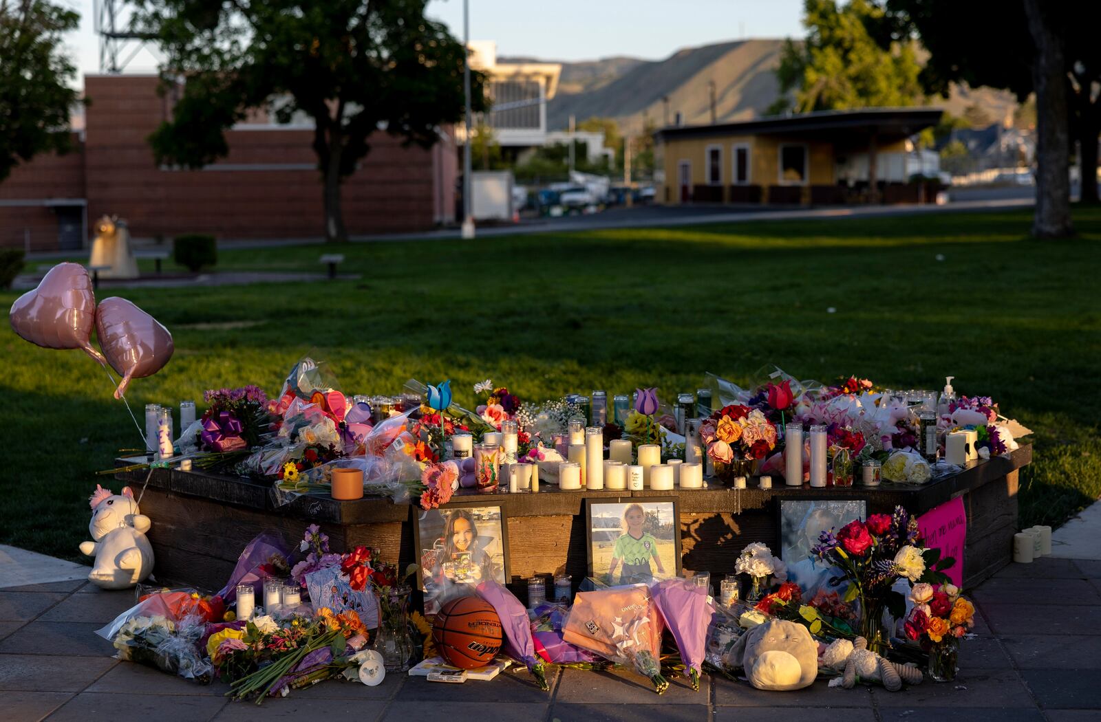 Pictures, flowers and candles mark a makeshift memorial Tuesday, June 3, 2025, in Wenatchee, Wash., in honor of Olivia, Paityn and Evelyn Decker, who were found dead near Leavenworth after their father Travis Decker failed to return them after a scheduled visitation. (Nick Wagner/The Seattle Times via AP)