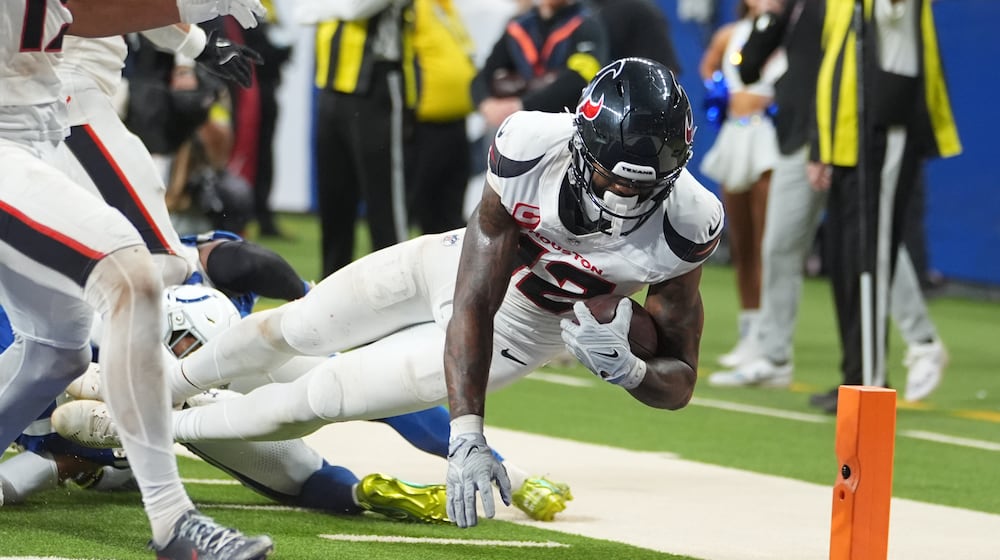 Houston Texans' Nico Collins (12) scores a touchdown against the Indianapolis Colts during the second half of an NFL football game Sunday, Nov. 30, 2025, in Indianapolis. (AP Photo/Michael Conroy)