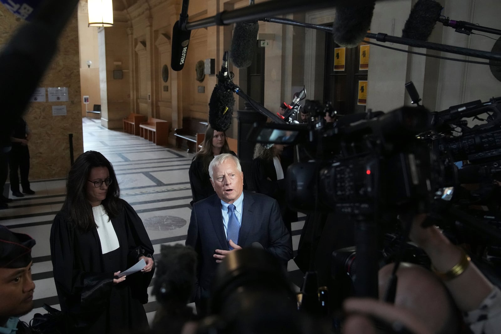 Michael Rhodes, lawyer for Kim Kardashian, speaks with the media at the justice palace after the testimony of his client regarding a robbery of millions of dollars in jewels from her Paris hotel room in 2016, in Paris, Tuesday, May 13, 2025. (AP Photo/Christophe Ena)