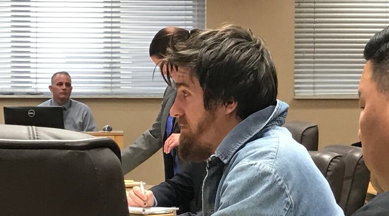 Dustin Merrick, 25, sits in court while his team of attorneys confer. Feb. 2, 2017. TREMAYNE HOGUE / STAFF