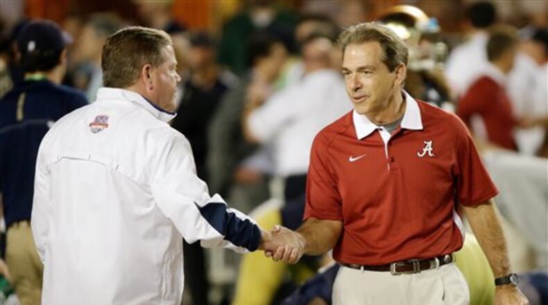 Notre Dame head coach Brian Kelly, left, shakes hands with Alabama head coach Nick Saban before the BCS National Championship college football game Monday, Jan. 7, 2013, in Miami. (AP Photo/David J. Phillip)