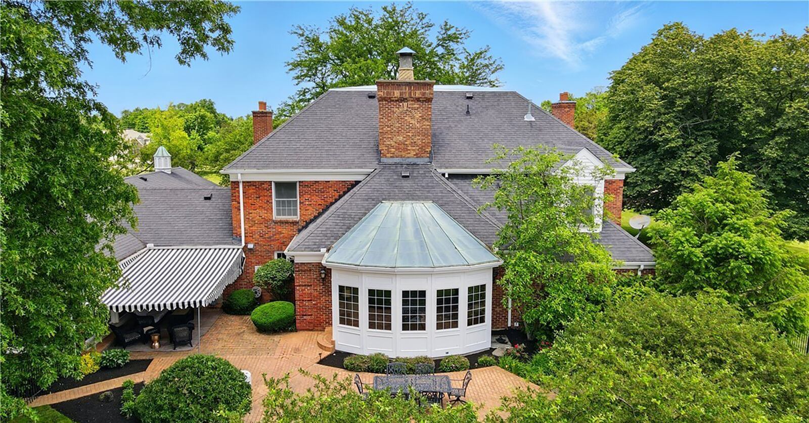 The rear of the home features a paver patio across most of the back of the home and a retractable awning.