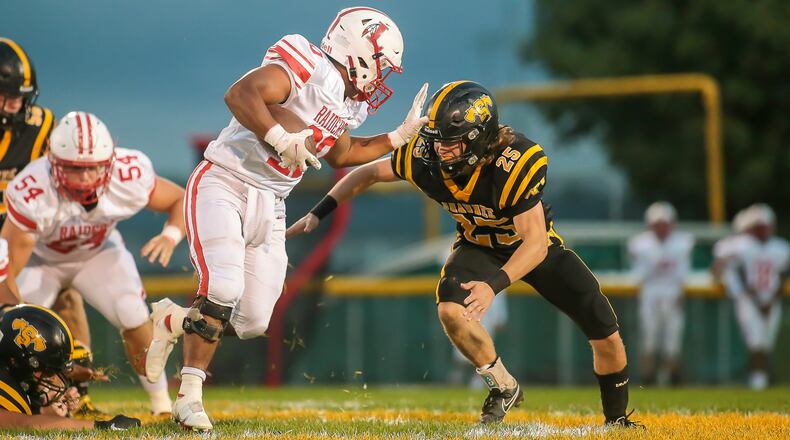 Cutline: Shawnee High School sophomore TJ Meeks tackles London's Antwaun Burns during their game on Friday night in Springfield. The Red Raiders beat the Braves 39-0. CONTRIBUTED PHOTO BY MICHAEL COOPER