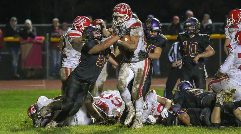 St. Henry senior Zach Niekamp runs for one of his four touchdowns on the night as the Redskins beat Mechanicsburg 37-7 in a Division VI, Region 24 quarterfinal game at Indian Stadium on Friday night. CONTRIBUTED PHOTO BY MICHAEL COOPER