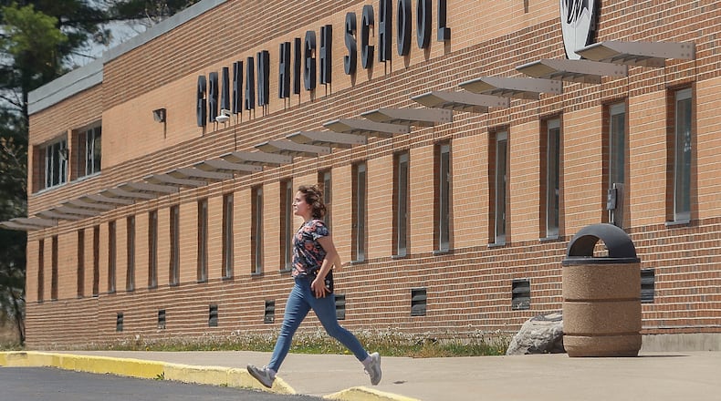 A student sprints to catch the bus at the end of the day on Thursday, April 24, 2025, at Graham High School. JOSEPH COOKE/STAFF