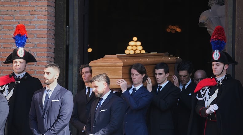 The casket of fashion designer Valentino Garavani leaves the St. Mary of Angels Basilica at the end of his funeral, in Rome, Friday, Jan. 23, 2026. (AP Photo/Andrew Medichini)