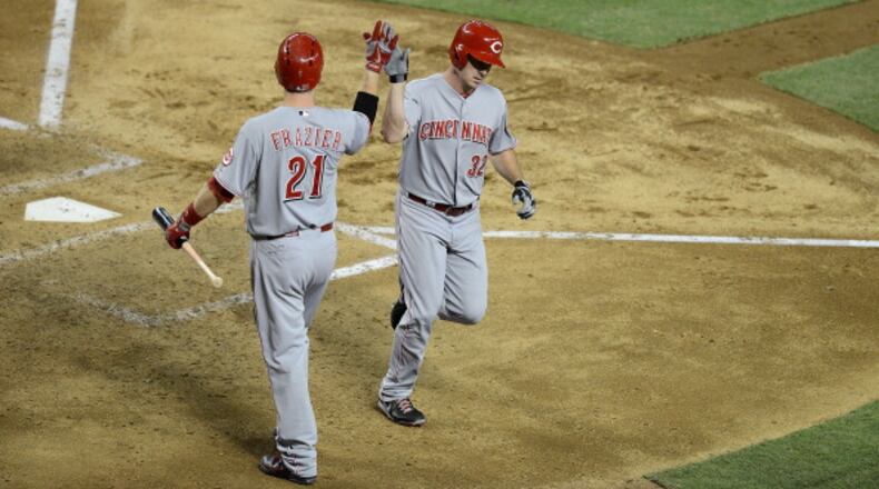 PHOENIX, AZ - JUNE 21: Jay Bruce #32 of the Cincinnati Reds is greeted at home plate by teammate Todd Frazier #21 after hitting a home run against the Arizona Diamondbacks at Chase Field on June 21, 2013 in Phoenix, Arizona. (Photo by Norm Hall/Getty Images)