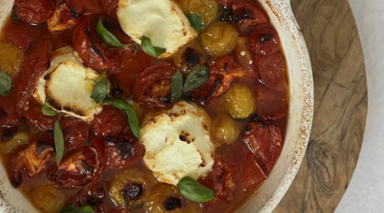 This recipe of cherry tomatoes, garlic cloves, goat cheese and more can be a time saver for people who haven't had time to fully cook something. WHITNEY KLING/CONTRIBUTED