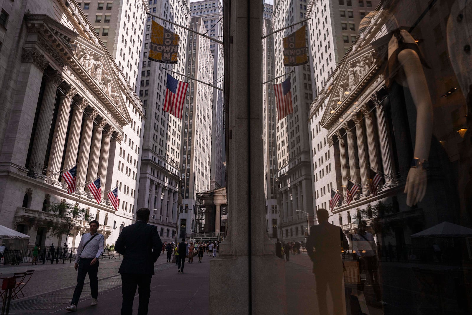 A reflection of a window shows the New York Stock Exchange on Monday, June 30, 2025, in New York. (AP Photo/Yuki Iwamura)