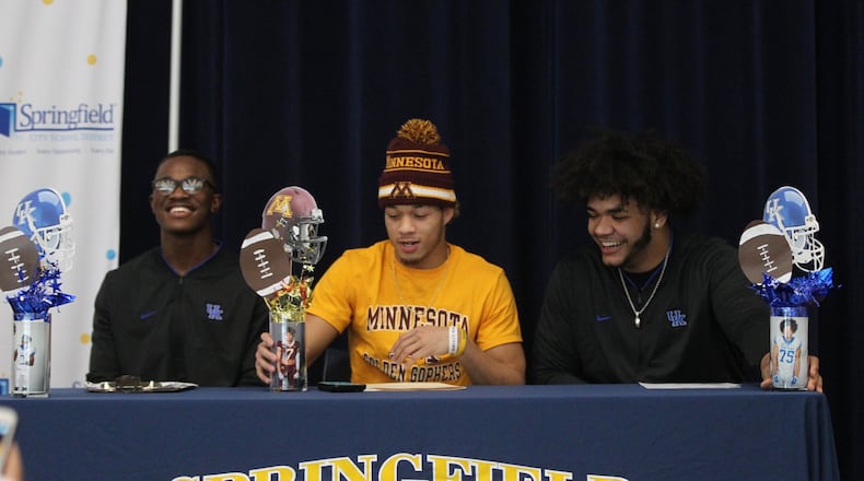 Springfield football players (left to right) Moses Douglass, Michael Brown-Stephens and Isaiah Gibson appear at a signing day ceremony at the high school on Wednesday, Dec. 19, 2018, in Springfield. David Jablonski/Staff