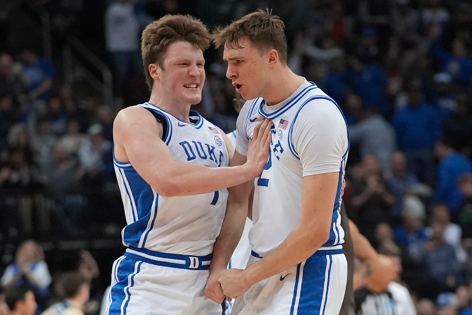 Duke guard Kon Knueppel (7) and forward Cooper Flagg (2) react after Flagg hit a three point basket to end the first half of a Sweet 16 round NCAA college basketball tournament game against Arizona, Thursday, March 27, 2025, in Newark, N.J. (AP Photo/Frank Franklin II)