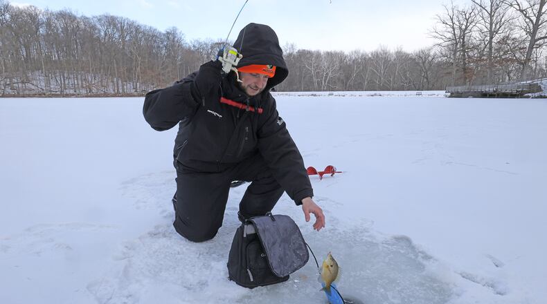 Drew Scanlan braves the below zero wind chill as he tries the ice fishing on Hosterman Lake at George Rogers Clark Park Tuesday, Jan. 21, 2025. With several days at below freezing temperatures, Scanlan said the ice is about five inches thick. BILL LACKEY/STAFF