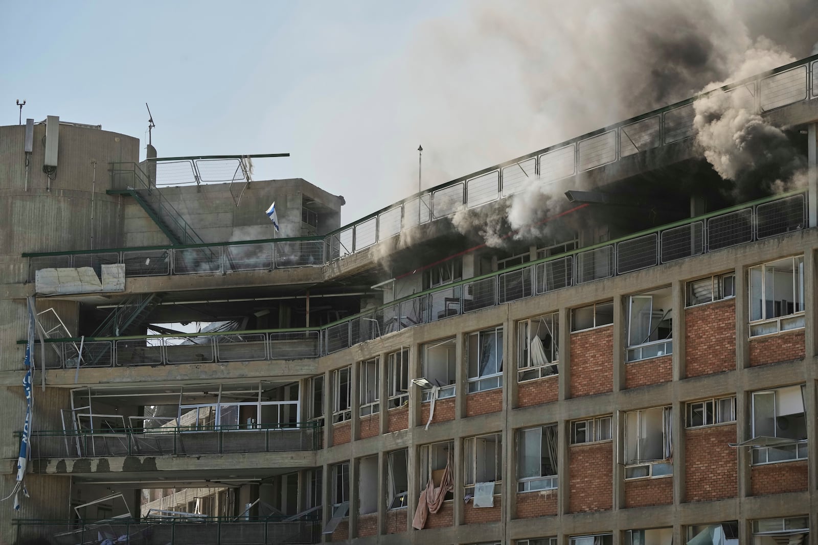 Smokes raises from a building of the Soroka hospital complex after it was hit by a missile fired from Iran in Be'er Sheva, Israel, Thursday, June 19, 2025. (AP Photo/Leo Correa)