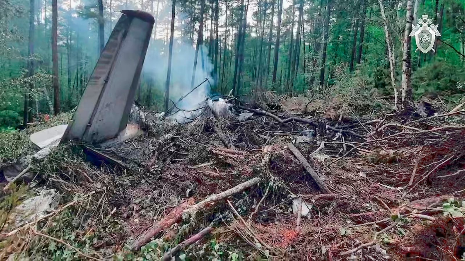 In this photo taken from video released by Russian Investigative Committee on Thursday, July 24, 2025, a view of the place of the crashed Russian An-24 passenger plane of the Siberia-based Angara Airlines while carrying 49 passengers in 15 kilometers (9 miles) south of Tynda, Far Eastern Amur region of Russia. (Russian Investigative Committee via AP)