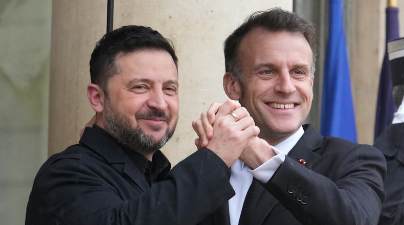 France's President Emmanuel Macron, right, welcomes Ukrainian President Volodymyr Zelenskyy prior to a meeting at the Elysee Palace, Friday, March 13, 2026, in Paris, France. (AP Photo/Michel Euler)