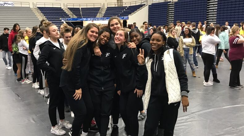 Fairmont teammates embrace Makira Webster (second from left ) after she gave a powerful speech on the troubling things she has endured past two years to Fairmont students. Tom Archdeacon/CONTRIBUTED